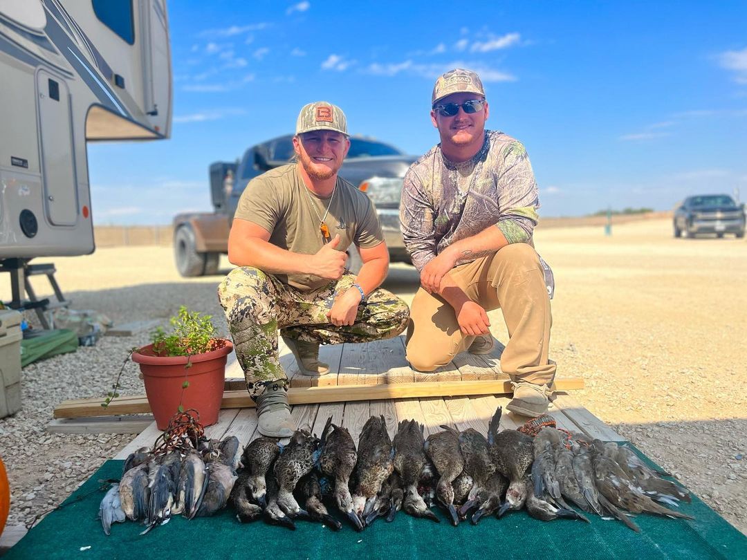 Two hunter men with ducks