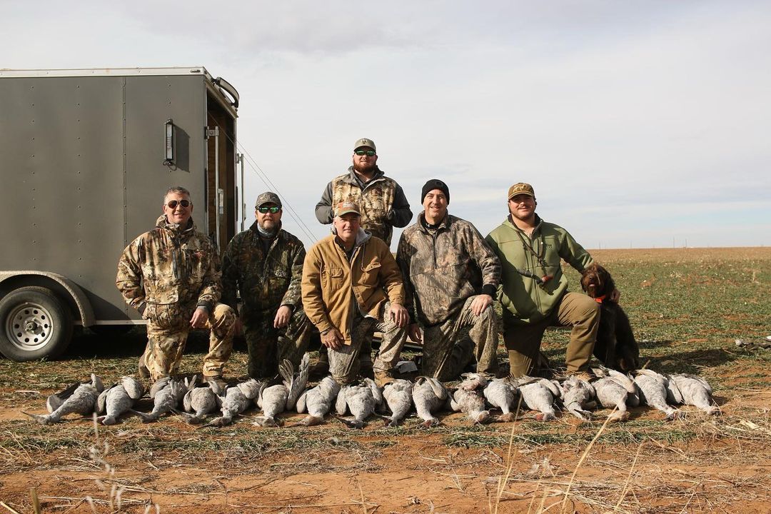 Group of hunters with cranes