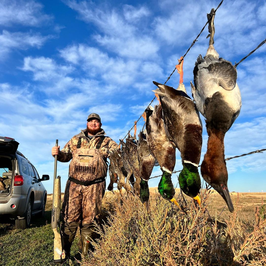 Hunter with hunted ducks