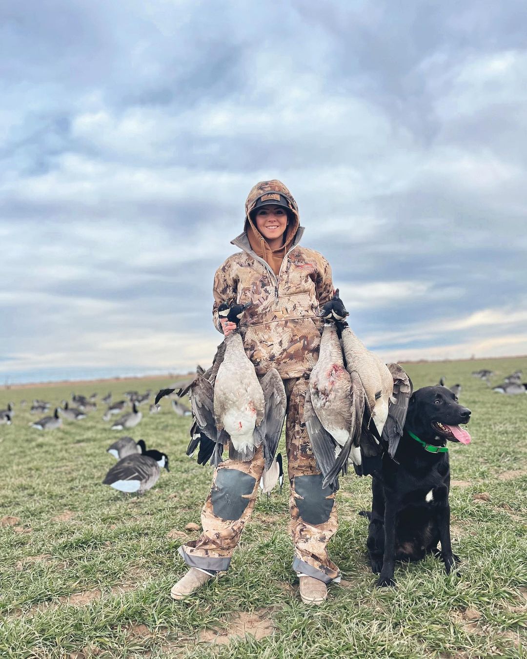 Woman hunter with hunting dog and geese