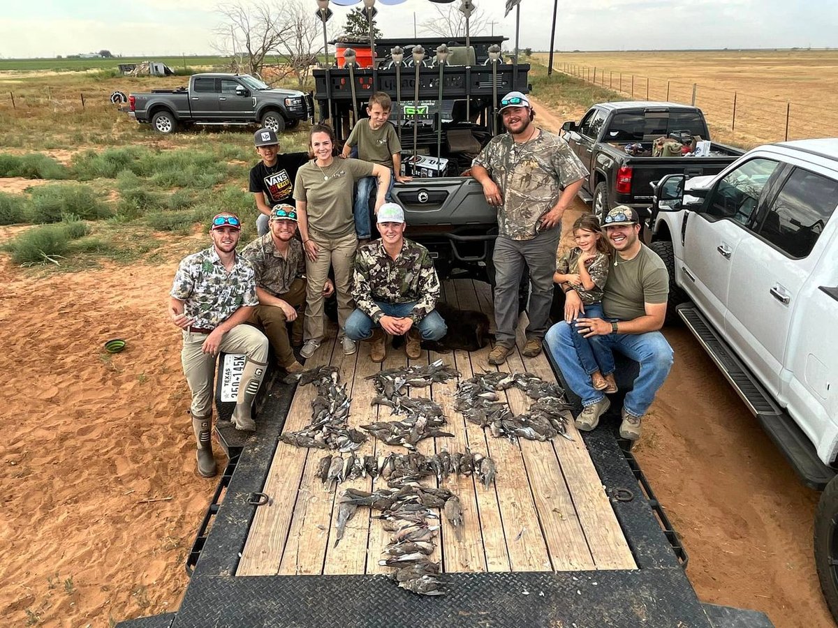 Group of hunters with deceased doves on trailer