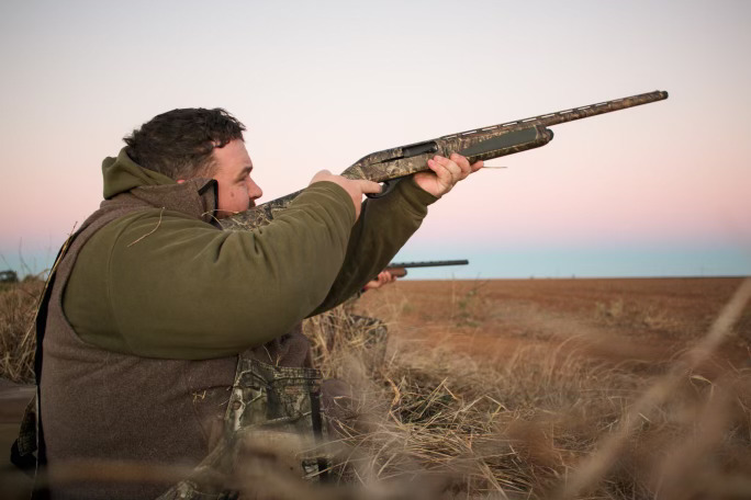 Man hunters shooting towards the sky