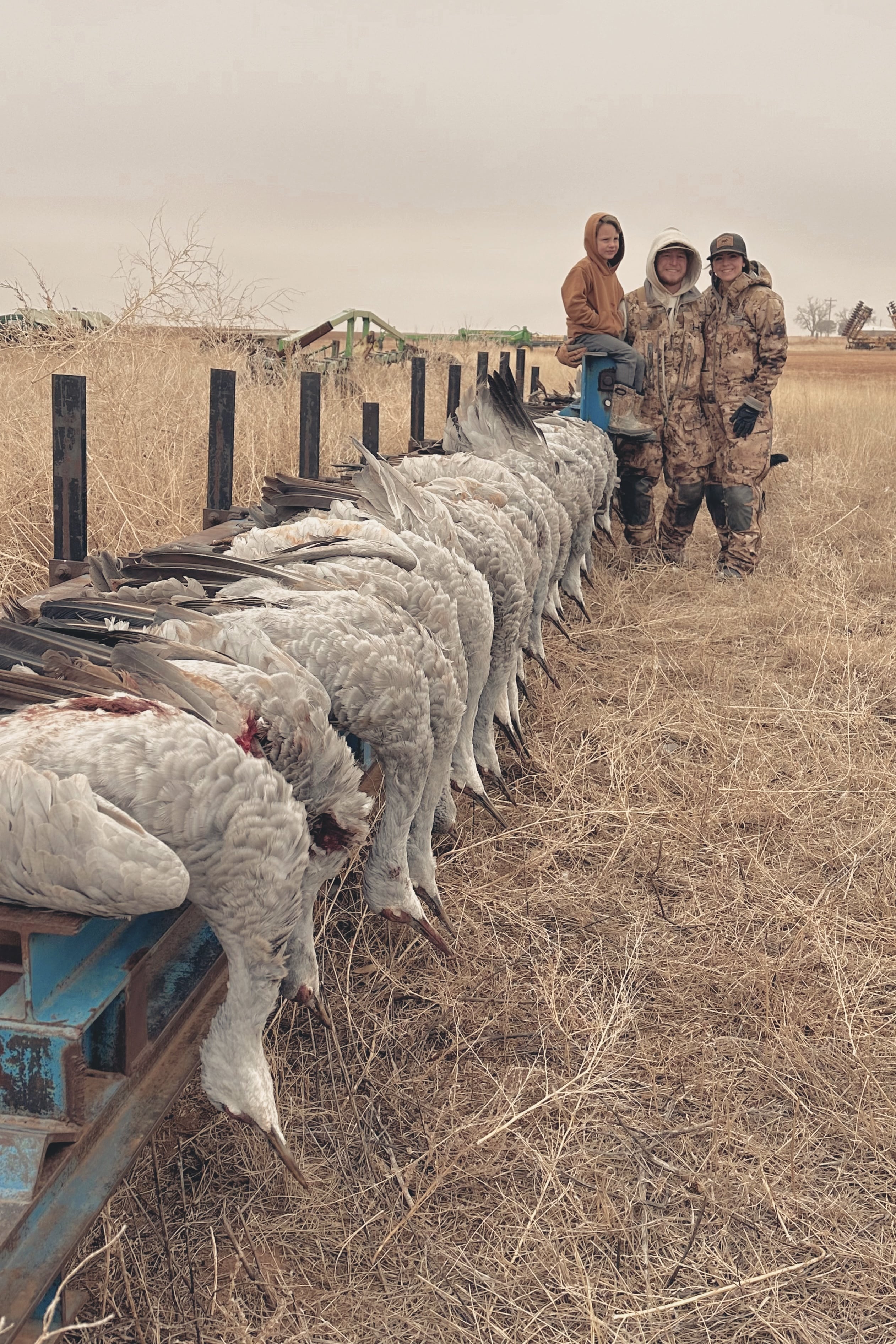 Small family of hunters with sandhill cranes